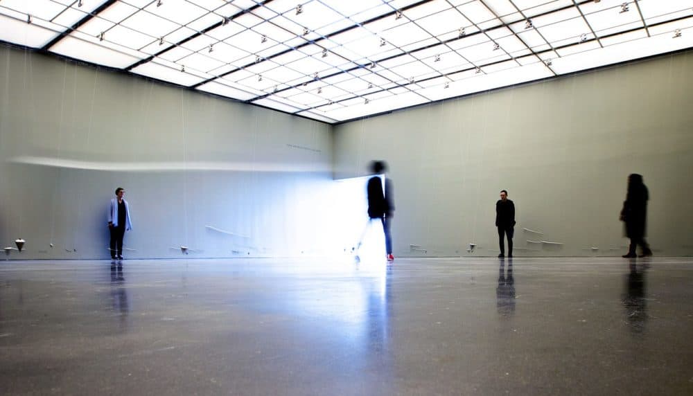 Eighty pendulums swing independently, as some participants move through and others contemplate their route, in the ever-evolving maze named “In Nowhere and Everywhere at the Same Time, No. 3.” (Jesse Costa/WBUR)