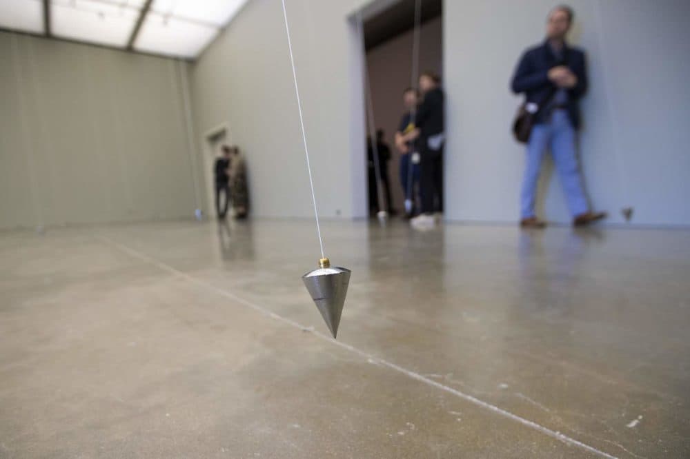 One of the 80 swinging pendulums of “In Nowhere and Everywhere at the Same Time, No. 3.” (Jesse Costa/WBUR)