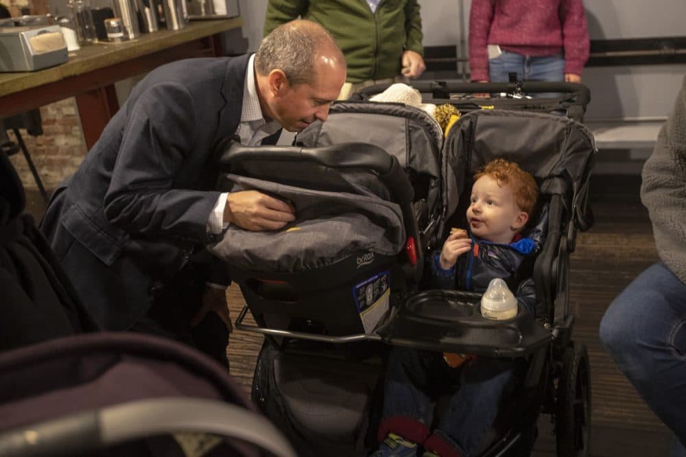 Gonzalez greets 2-and-a-half-year-old Patrick Fellony during his campaign visit to Somerville. (Jesse Costa/WBUR)