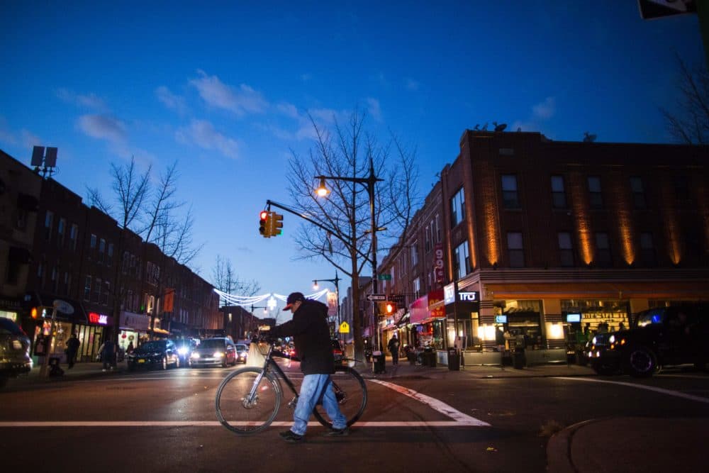 People walk on a local street past restaurants in Astoria in the Queens borough of New York. (Eduardo Munoz Alvarez/AFP/Getty Images)
