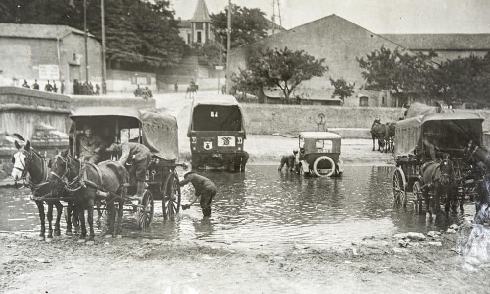 Members of the 104th Ambulance Company washing vehicles. July, 1918. (Massachusetts National Guard Archives)