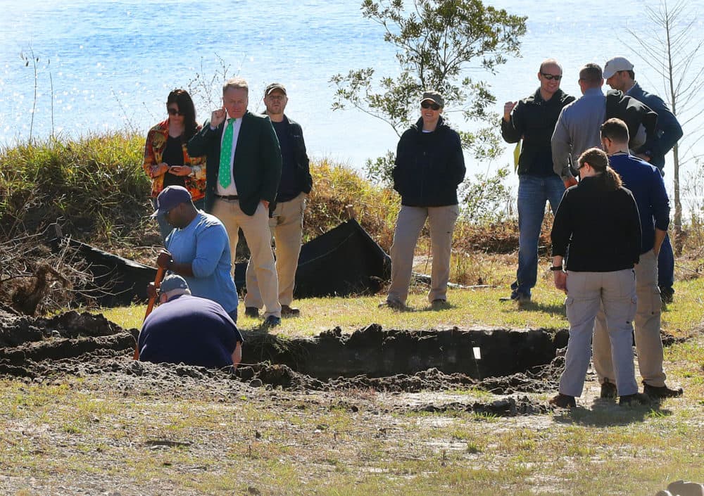 The FBI, investigators and excavation personnel at the scene of a lot in Orlando where an excavator dug up a section of the yard in hopes of finding the stolen Gardner Museum artwork. (John Tlumacki/Boston Globe)