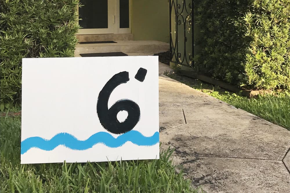 A repurposed campaign sign in front of Xavier Cortada's home, which sits 6 feet above sea level. (Courtesy of Xavier Cortada)