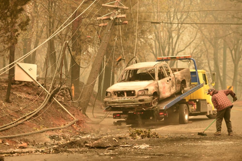 Crews begin removing abandoned vehicles from the streets after the Camp fire tore through the area in Paradise, California on November 12, 2018. - Thousands of firefighters spent a fifth day digging battle lines to contain California's worst ever wildfire as the wind-whipped flames cleaved a merciless path through the state's northern hills, leaving death and devastation in their wake. The Camp Fire -- in the foothills of the Sierra Nevada mountains north of Sacramento -- has killed 29 people, matching the state's deadliest ever brush blaze 85 years ago. More than 200 people are still unaccounted for, according to officials. (Photo by Josh Edelson / AFP)        (Photo credit should read JOSH EDELSON/AFP/Getty Images)