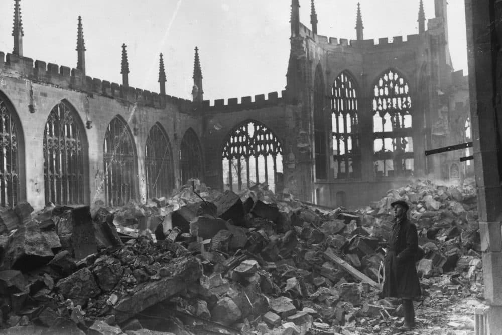 A man stands in the ruins of Coventry Cathedral on Nov. 16, 1940, after a German nighttime air raid destroyed the center of the city. (George W. Hales/Fox Photos/Getty Images)