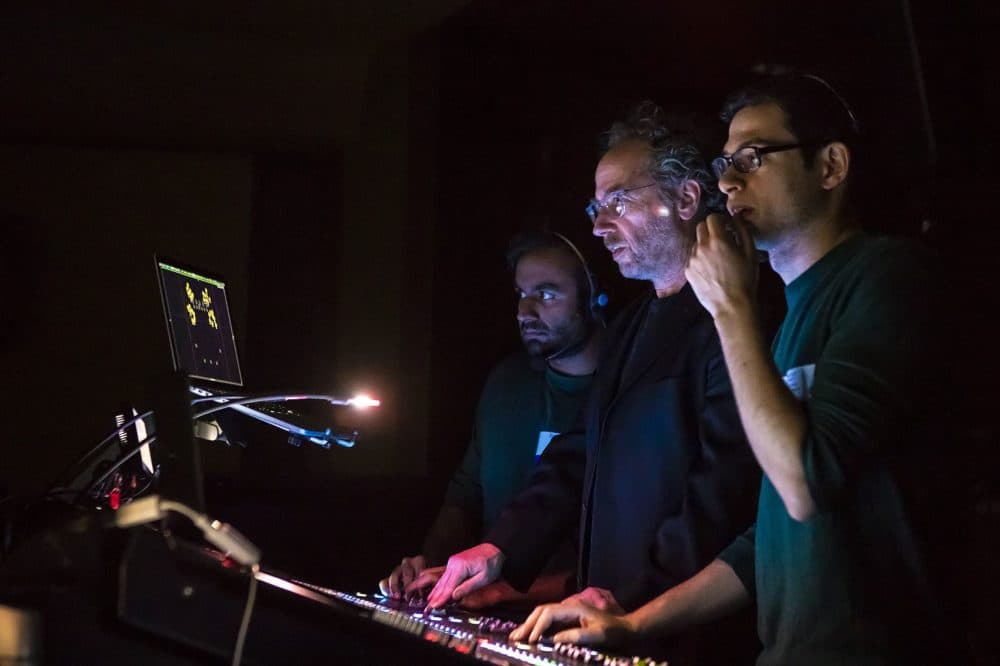 Composer Tod Machover, center, works the sound board during the dress rehearsal of &quot;Schoenberg In Hollywood&quot; along with sound designer Ben Bloomberg, right, and research assistant Nikhi Singh. (Jesse Costa/WBUR)