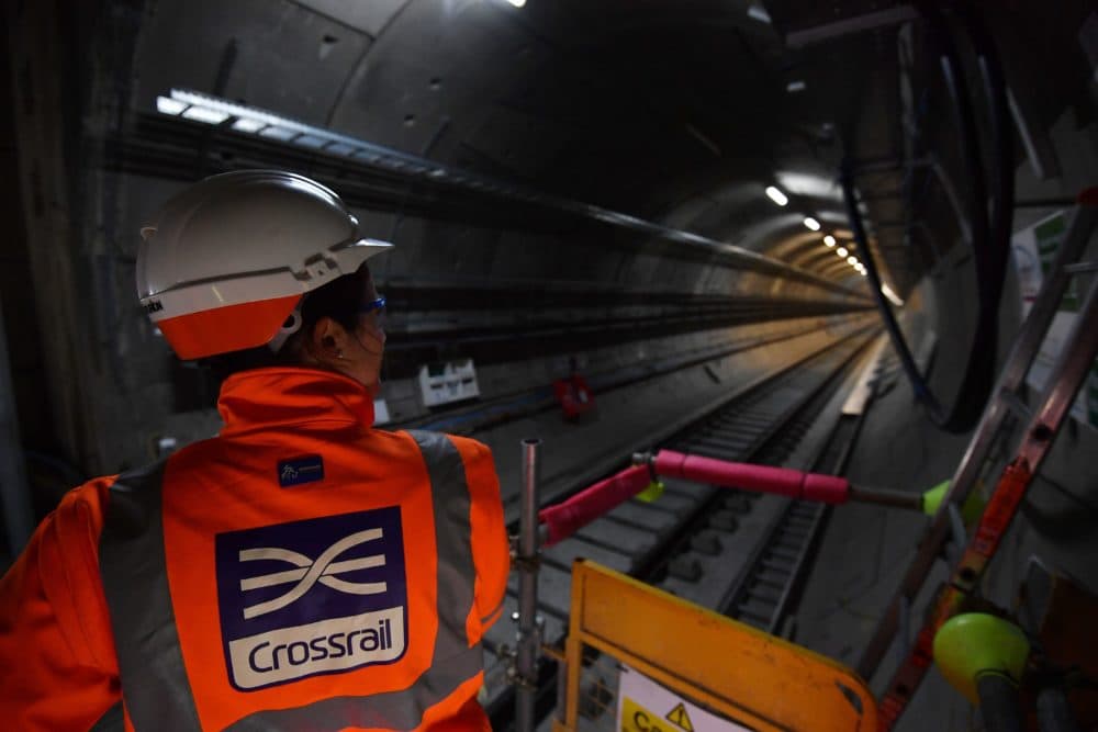 A worker looks along a train tunnel at the Canary Wharf Crossrail station in London on Feb. 8, 2017. (Ben Stansall/AFP/Getty Images)