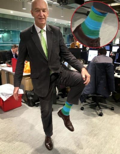 Jon Snow shows off one of his many colorful pairs of socks. (Jeremy Hobson/Here &amp; Now)