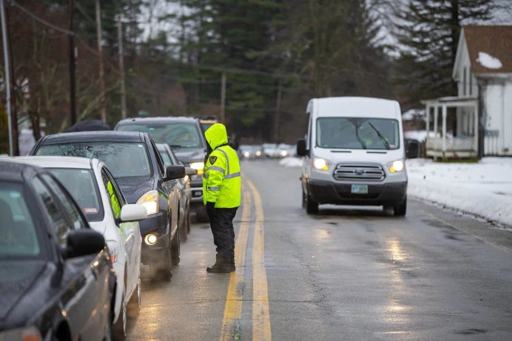 Cars wait on Main Street to park in a lot about a quarter of a mile away from Cultivate. From there customers are shuttled to the facility from the parking lot using vans. (Jesse Costa/WBUR)