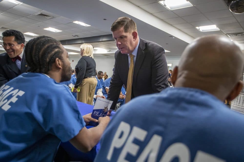 Boston Mayor Marty Walsh chats with some of the inmates at a press conference about the Suffolk County Sheriff’s Department's PEACE unit. (Jesse Costa/WBUR)
