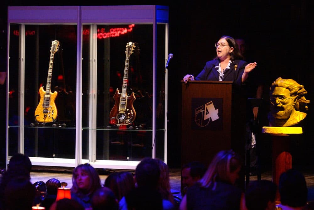Guernsey's auctioneer Joanne Grant conducts bidding on guitars previously owned by the late Jerry Garcia during an auction Wednesday, May, 8, 2002, at Studio 54 in New York. The guitar named &quot;Wolf,&quot; left, sold for $700,000 and &quot;Tiger&quot; sold for $850,000. (AP Photo/Chad Rachman)