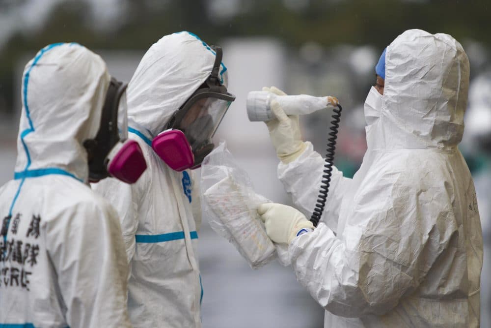 A man is checked for radiation after arriving at a vehicle decontamination center at J-Village, a soccer training complex now serving as an operation base for those battling Japan's nuclear disaster at the tsunami-damaged Fukushima Dai-ichi nuclear plant, in Fukushima prefecture, Japan, Friday, Nov. 11, 2011. (David Guttenfelder/AP)
