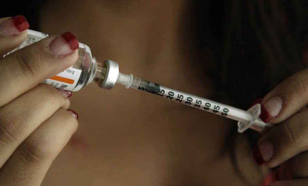 Judith Garcia, 19, fills a syringe as she prepares to give herself an injection of insulin at her home in the Los Angeles suburb of Commerce, Calif., Sunday, April 29, 2012. (Reed Saxon/AP)