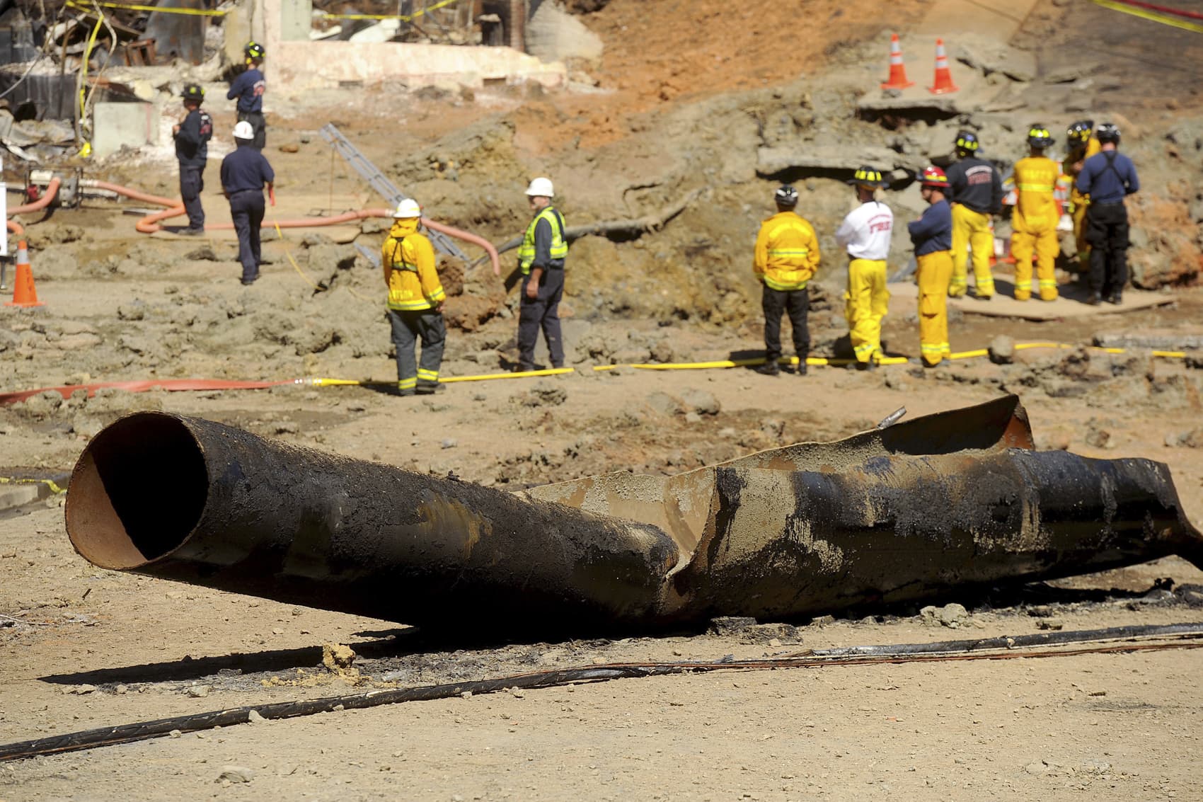 In this Sept. 11, 2010, file photo, a natural gas line lies broken on a San Bruno, Calif., road after a massive explosion. A federal jury found Pacific Gas & Electric Co., California's largest utility, guilty on Tuesday, Aug. 9, 2016, of misleading investigators about how it was identifying high-risk pipelines after the deadly gas line explosion in the San Francisco Bay Area. (AP Photo/Noah Berger, File)