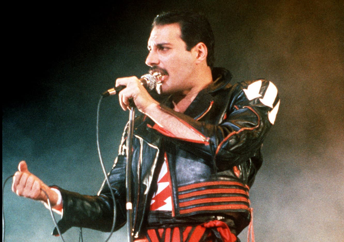 FILE - In this 1985 file photo, singer Freddie Mercury of the rock group Queen, performs at a concert in Sydney, Australia. Queen guitarist Brian May says an asteroid in Jupiter's orbit has been named after the band's late frontman Freddie Mercury on what would have been his 70th birthday, it was reported on Monday, Sept. 5, 2016. May says the International Astronomical Union's Minor Planet Centre has designated an asteroid discovered in 1991, the year of Mercury's death, as "Asteroid 17473 Freddiemercury." (AP Photo/Gill Allen, File)