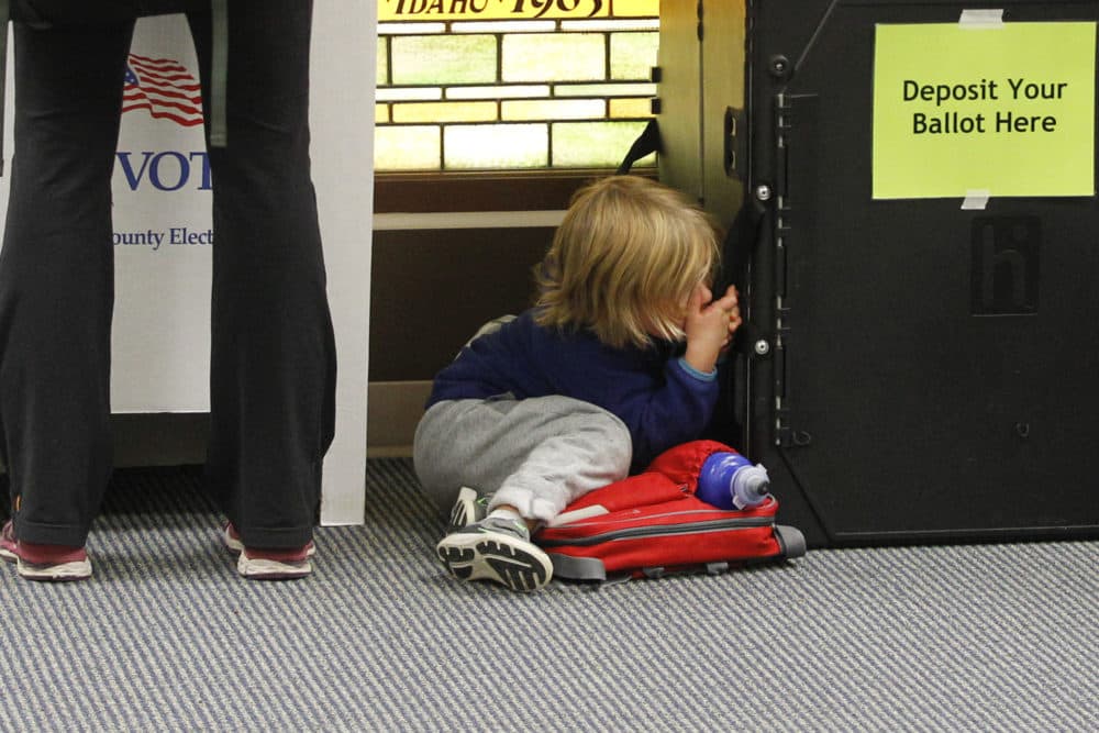 A child waits while their parent votes at Cathedral of the Rockies in Boise, Idaho, on Tuesday, Nov. 8, 2016. (Otto Kitsinger/AP)