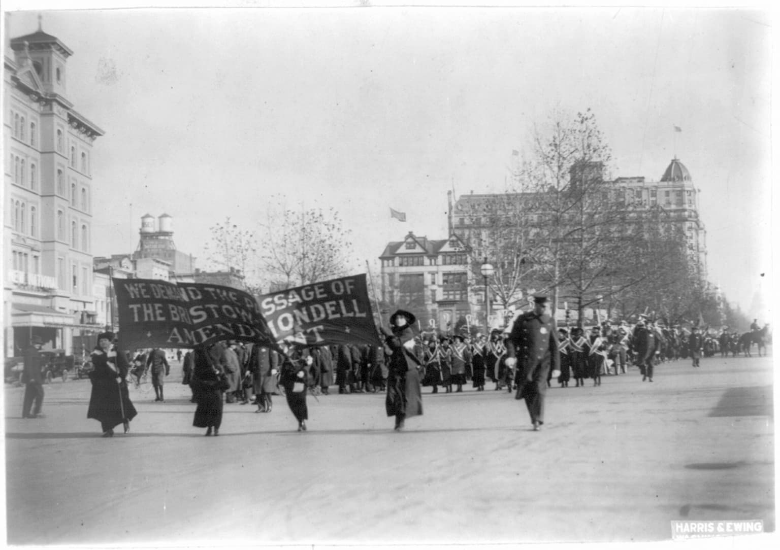 In this photo provided by the Library of Congress, taken in 1913, four women march ahead of large procession with the banner "We demand the passage of the Bristow-Mondell amendment" at the woman suffrage parade in Washington. (AP)