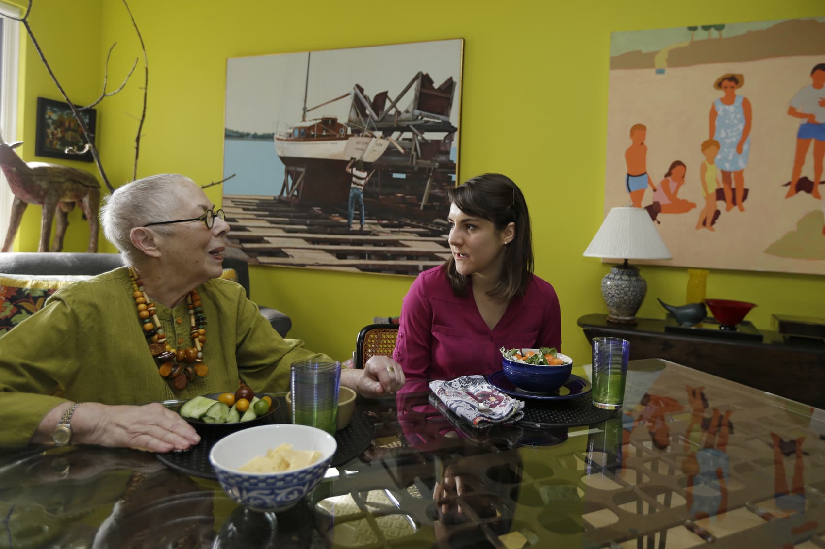 Laura Berick, left, a retired art dealer, has lunch with Justine Myers at Berick's home in Judson Manor, in Cleveland, Feb. 17, 2017. (Tony Dejak/AP)