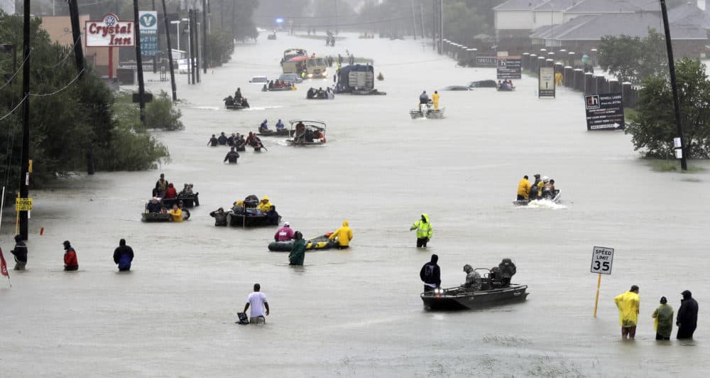 Rescue boats float on a flooded street as people are evacuated from rising floodwaters brought on by Tropical Storm Harvey on Aug. 28, 2017, in Houston. (David J. Phillip/AP)