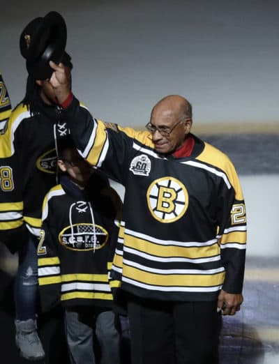 Former Boston Bruins wing Willie O'Ree tips his hat as he is honored prior to the first period of an NHL hockey game against the Montreal Canadiens in Boston, Wednesday, Jan. 17, 2018. O'Ree broke the NHL's color barrier 60 years ago while playing a game against the Canadiens in 1958. (Charles Krupa/AP)