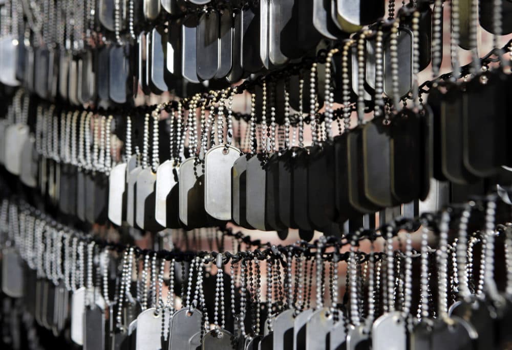 In this Wednesday, Nov. 7, 2018 photo, blank military dog tags hang in a memorial honoring fallen soldiers from the conflicts in Iraq and Afghanistan, on the grounds of Old North Church, in Boston. (Steven Senne/AP)