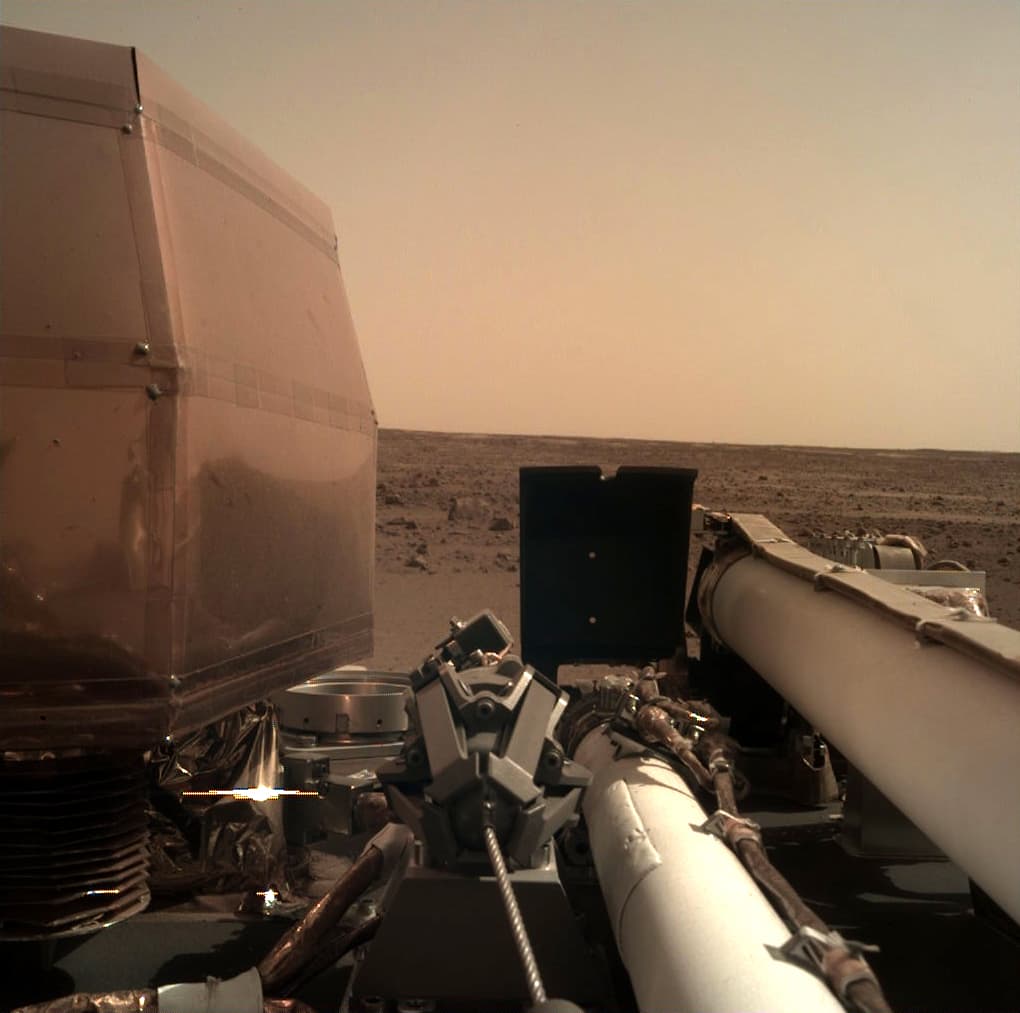 This photo provided by NASA shows an image on Mars that its spacecraft called InSight acquired using its robotic arm-mounted, Instrument Deployment Camera (IDC) after it landed on the planet on Monday, Nov. 26, 2018. (NASA via AP)