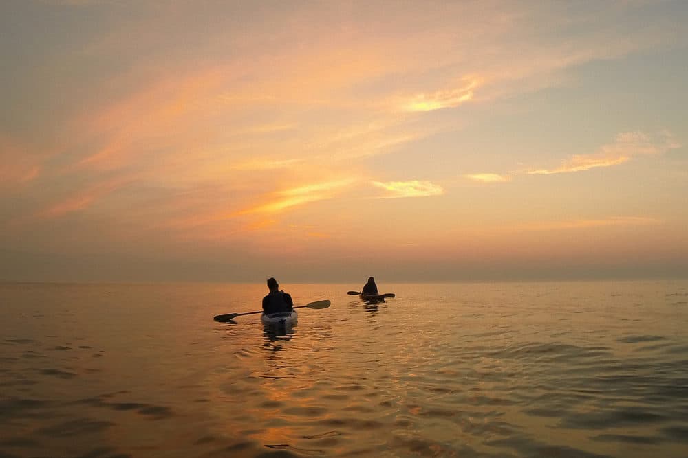 Kayakers paddle on Lake Michigan at sunrise, Monday, Aug. 17, 2015, in Cedar Grove, Wis. (AP Photo/Julio Cortez)