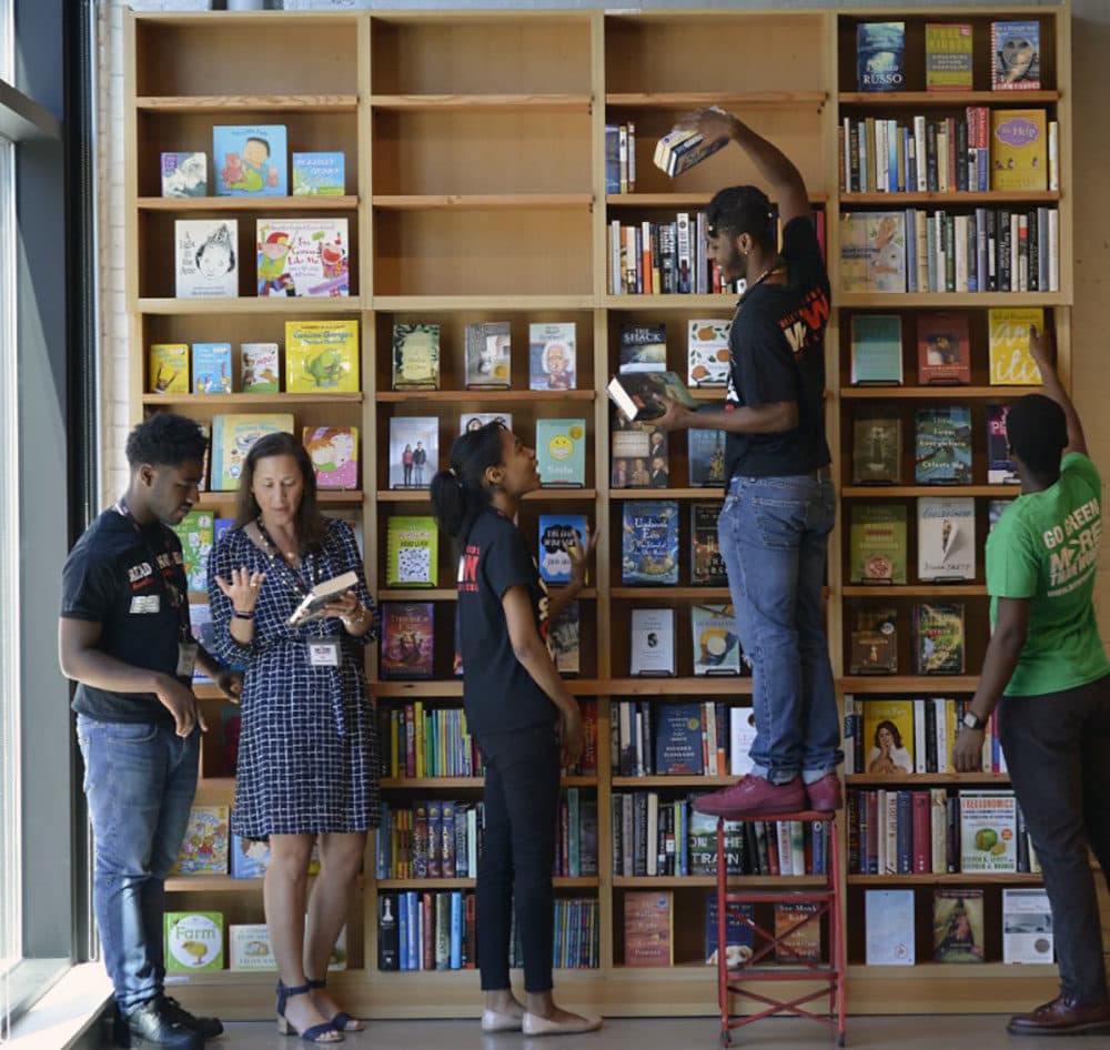 More Than Words Founder and CEO Jodi Rosenbaum, second from left, talks to employees at the newly expanded bookstore. (Courtesy of More Than Words)