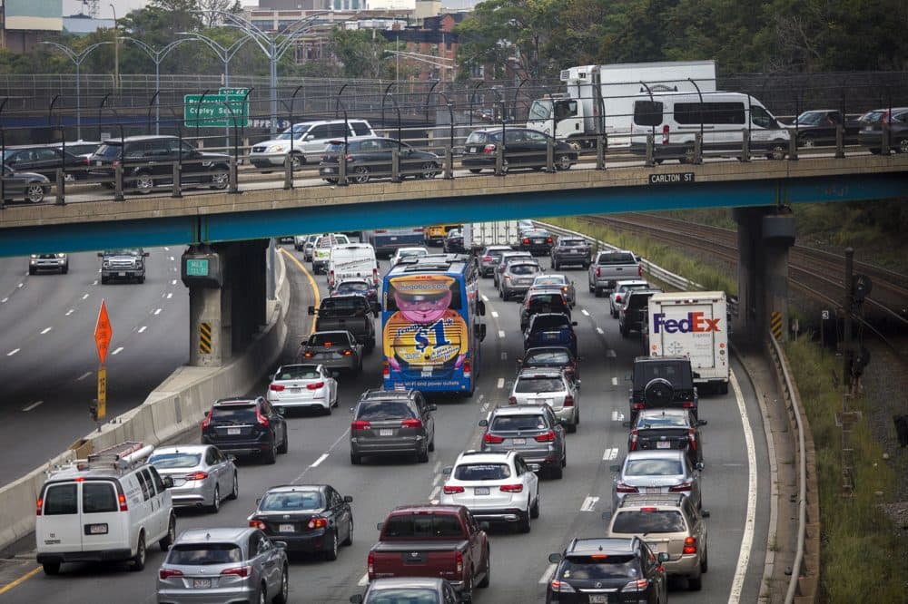 The Friday evening commute begins as cars jam up on the Mass. Pike and on the overpass on Carlton Street in Brookline. (Jesse Costa/WBUR)
