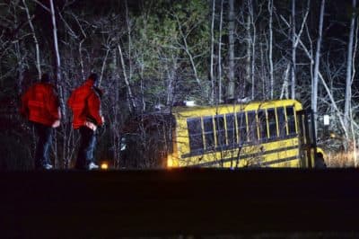 Emergency medical crew respond to a school bus that crashed into the woods off Route 24 south in Berkley, Mass., on Saturday, Dec. 1, 2018. The group was returning back to Tiverton, R.I. from LaSalette Shrine in North Attleboro, Mass. (Marc Vasconcellos/The Enterprise via AP)