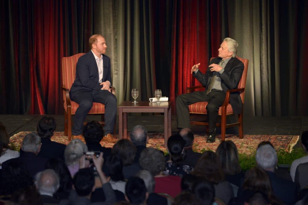 Michael Douglas talks with Here &amp; Now's Jeremy Hobson at Boston University's Howard Gotlieb Archival Research Center. (Courtesy of Allan Dines Photography/Boston University)