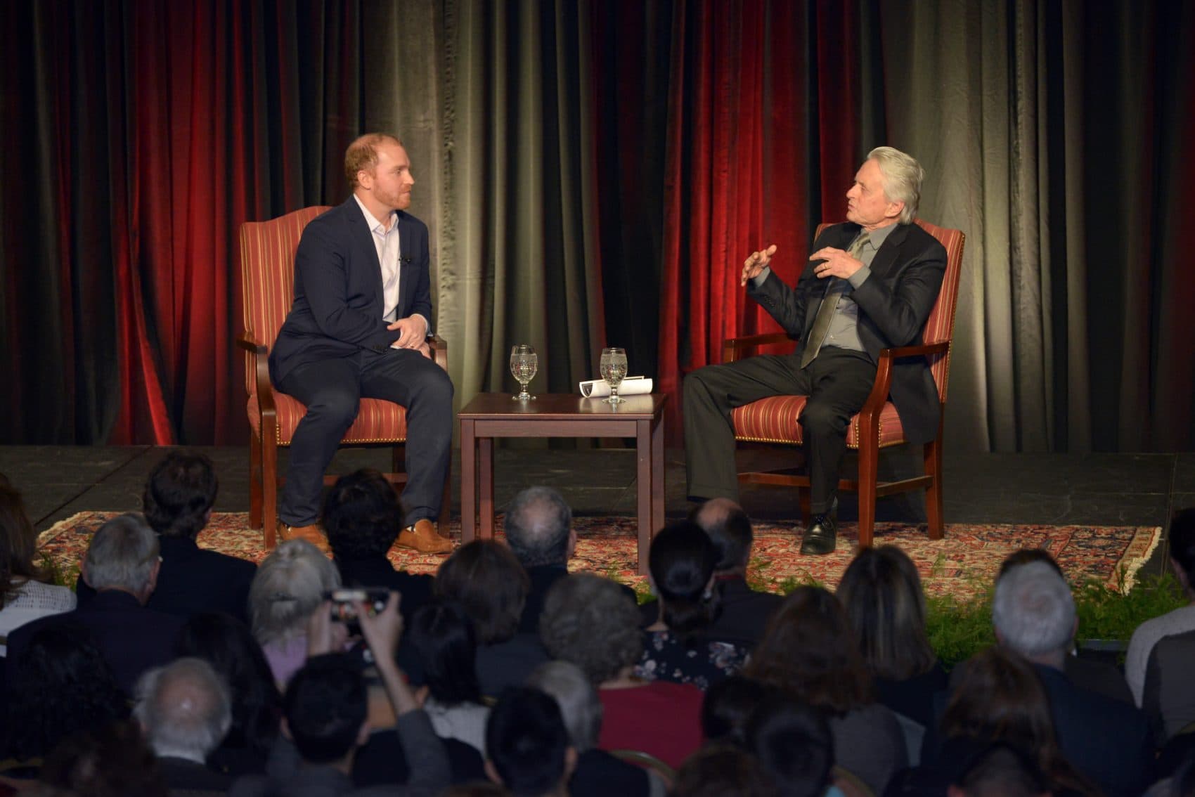 Michael Douglas talks with Here & Now's Jeremy Hobson at Boston University's Howard Gotlieb Archival Research Center. (Courtesy of Allan Dines Photography/Boston University)