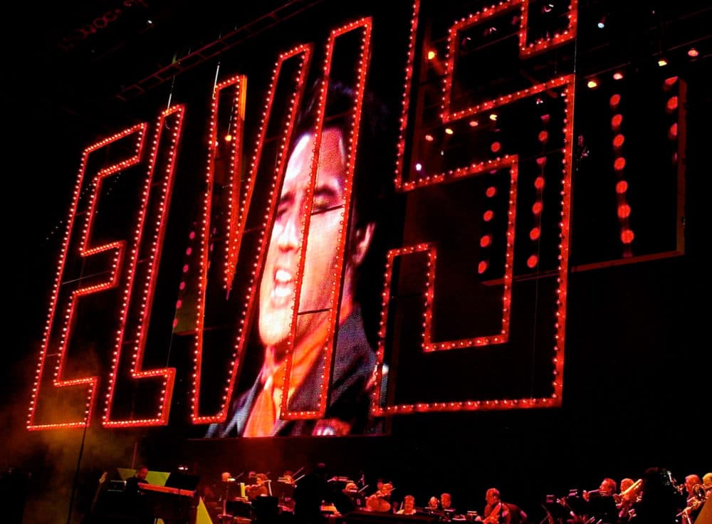 The red &quot;Elvis&quot; sign from the 1968 Elvis &quot;comeback special&quot; is projected at the start of the Elvis Presley 25th Anniversary Concert in Memphis, Tenn., in 2002. (Stephan Savoia/AP)