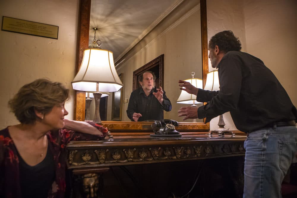 Actor Jeremiah Kissel recites lines from &quot;A Christmas Carol&quot; in the mirror Charles Dickens used to rehearsal during his stays at the Parker House in Boston. (Jesse Costa/WBUR)