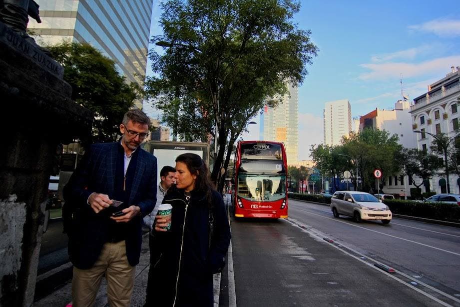 Will Foley of Cushman & Wakefield and Rebecca Leventhal of Higher Ground Labs walk down the street in Mexico City after riding the Metrobus. (Courtesy Alliance for Business Leadership)