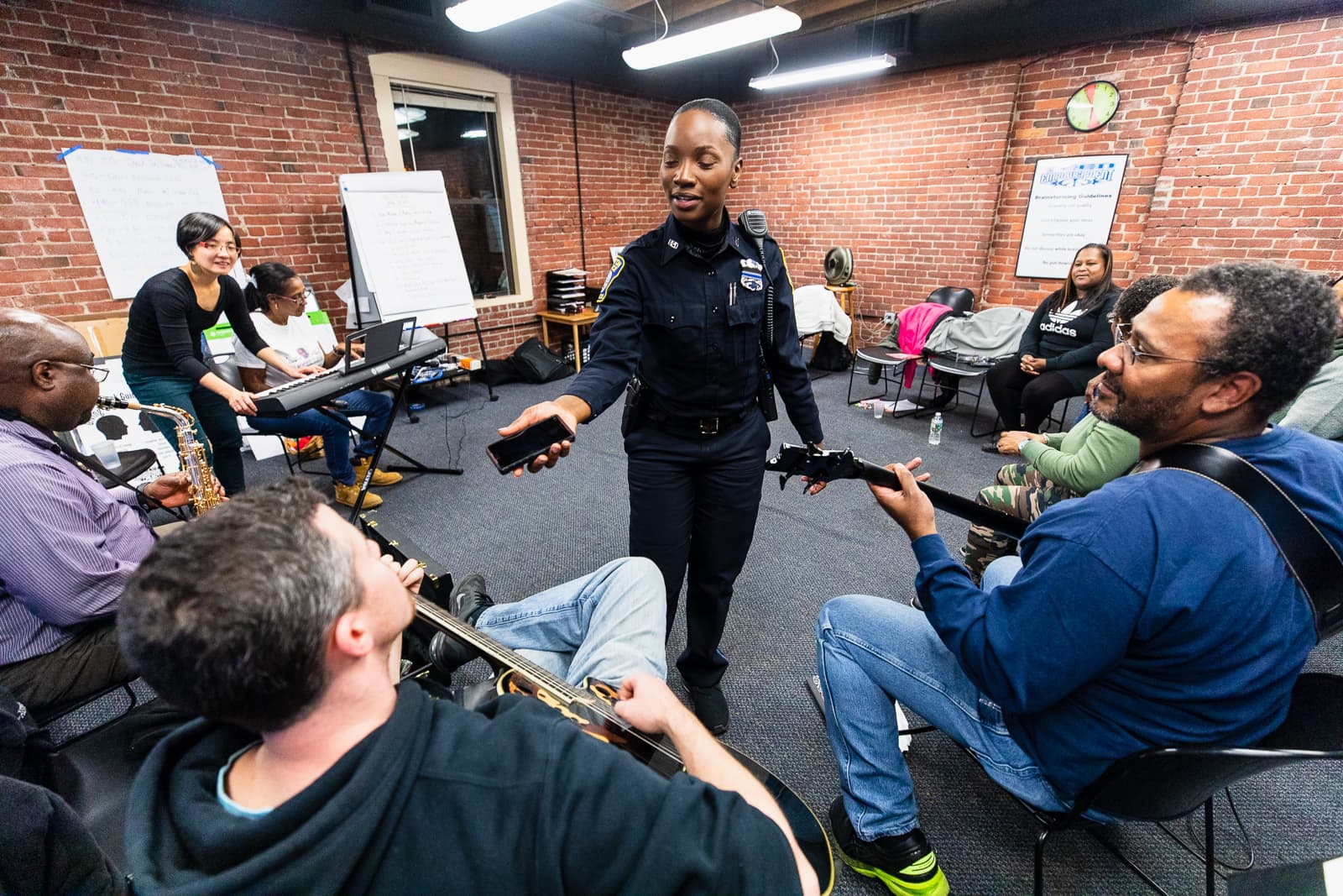 Kerline Desire, a Boston police officer, talks with colleagues at a "Code Listen" rehearsal. Desir says her experience with Code Listen reminds her that there’s “a story behind each victim we encounter on the streets. (Courtesy Celebrity Series)