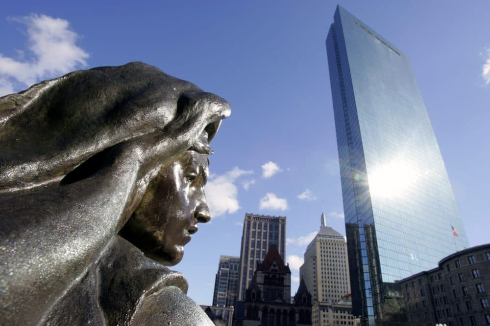 In this Nov. 17, 2005 file photo, sunlight reflects off the John Hancock Tower onto a statue outside the Boston Public Library in Boston. (AP Photo/Michael Dwyer, File)