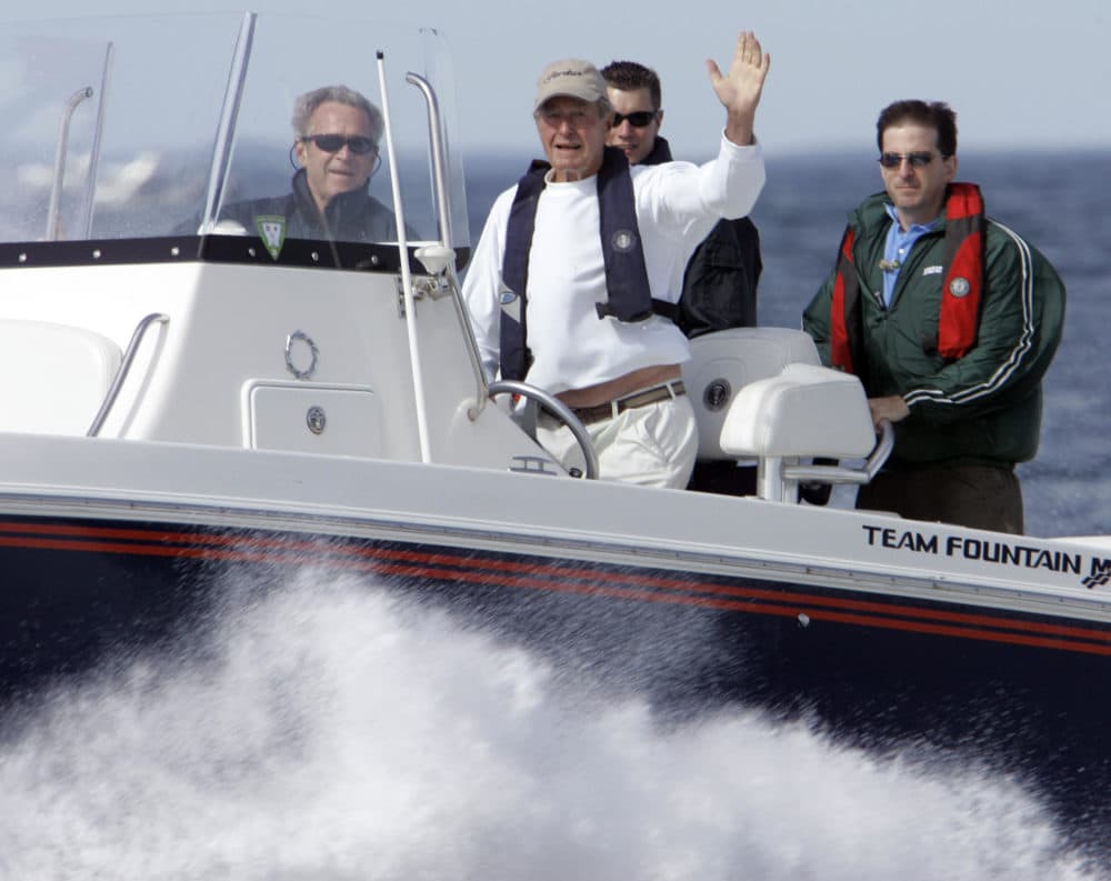 President Bush, front left, rides with his father, former President George H. W. Bush waving from his speedboat, Fidelity III, as they head back to Walker's Point after fishing Thursday, Aug. 9, 2007, off Kennebunkport, Maine. The other two men are unidentified. (Robert F. Bukaty/AP)