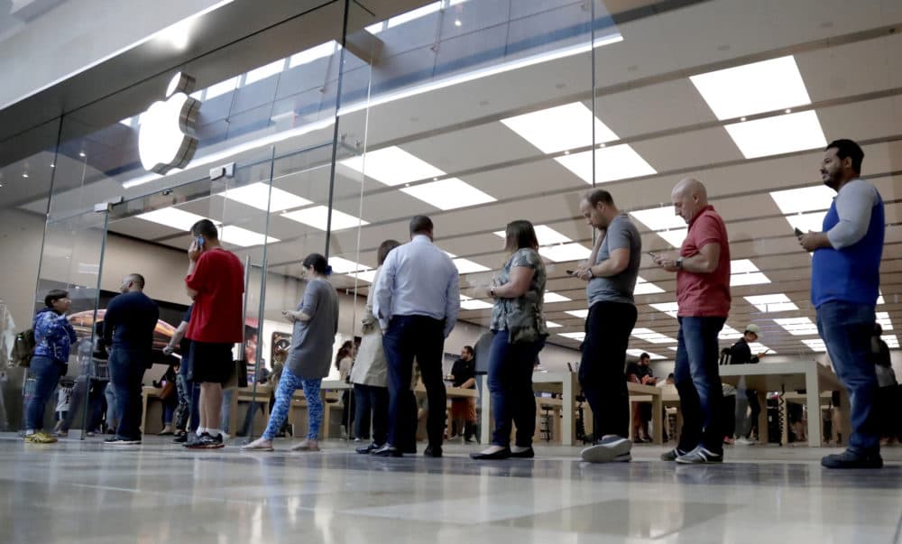 In this Sept. 21, 2018, file photo customers wait in line outside of the Apple Store at the Garden State Plaza on the day the new iPhone XS and iPhone XS Max were released in Paramus, N.J. (Julio Cortez/AP)