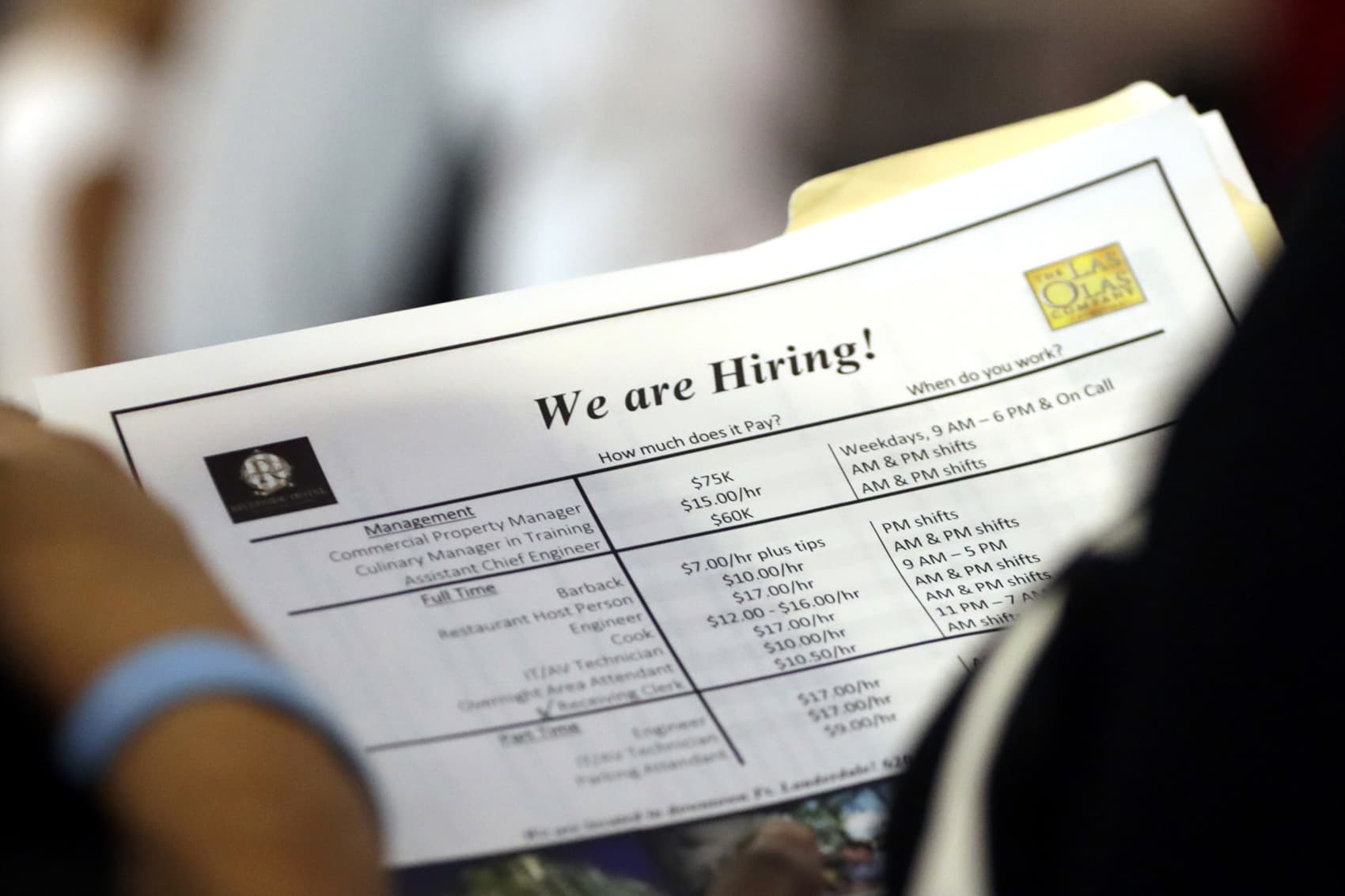 A job applicant looks at job listings for the Riverside Hotel at a job fair hosted by Job News South Florida, in Sunrise, Fla, June 21, 2018. (Lynne Sladky/AP)