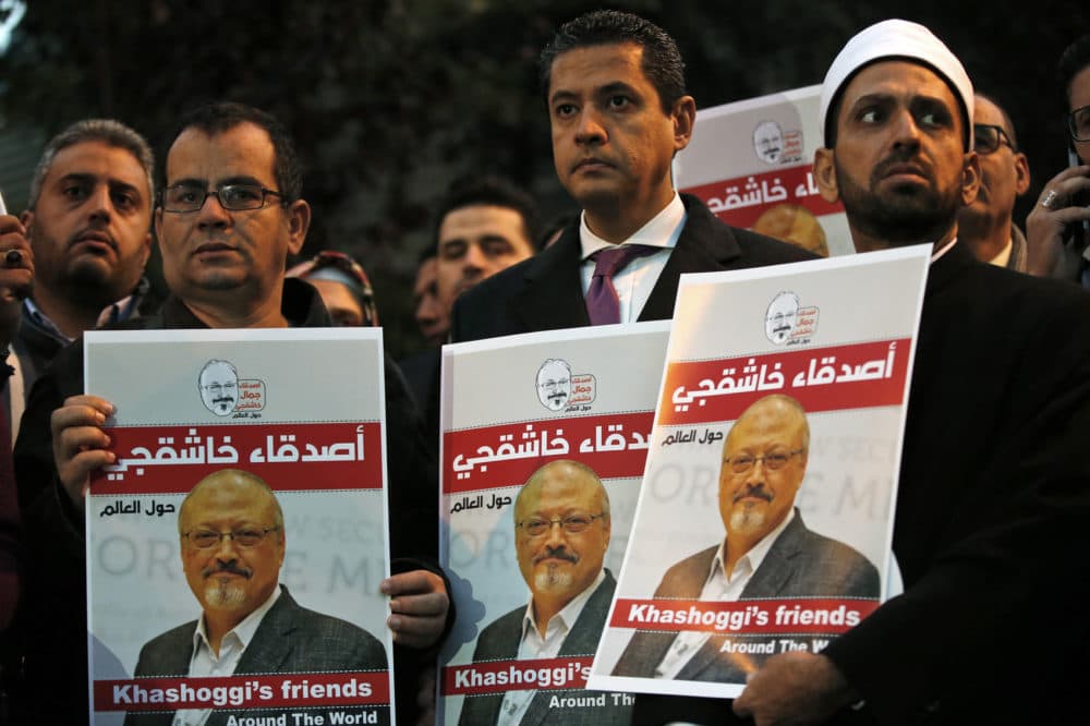 Activists protesting the killing of Saudi journalist Jamal Khashoggi hold a candlelight vigil outside Saudi Arabia's consulate in Istanbul in Oct. (Lefteris Pitarakis/AP)