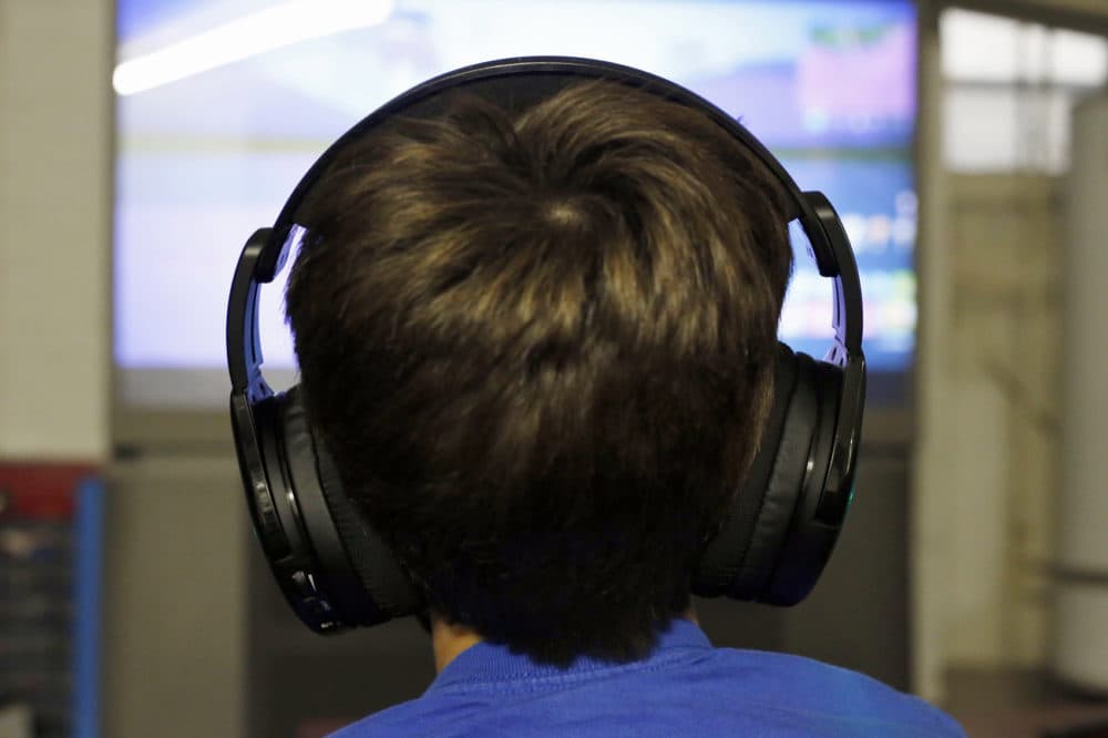 Henry Hailey, 10, plays Fortnite in the early morning hours in the basement of his Chicago home on Saturday, Oct. 6, 2018. His parents are on a quest to limit screen time for him and his brother. The boys say they understand sometimes, but also complain that they get less screen time than their friends. (Martha Irvine/AP)