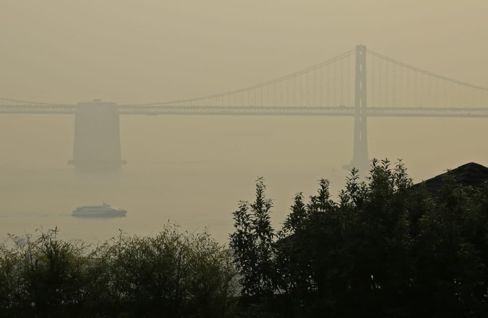 A ferryboat and the San Francisco-Oakland Bay Bridge are obscured due to smoke and haze from wildfires Monday, Nov. 19, 2018, in San Francisco. (Eric Risberg/AP)