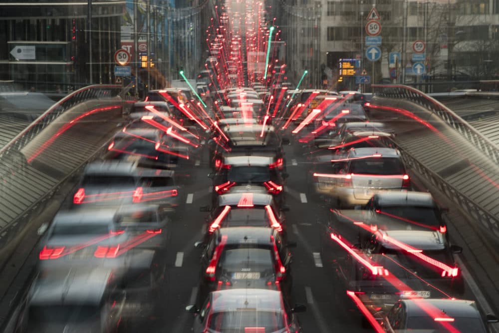 In this slow-shutter zoom effect photo, commuters backed up in traffic during the morning rush hour Wednesday, Dec. 12, 2018, in Brussels, a city that regularly experiences pollution alert warnings. (Francisco Seco/AP)
