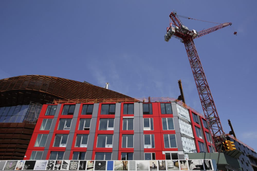 A construction crane towers over a modular apartment building next to the Barclay's Center, Monday, May 5, 2014 in the Brooklyn borough of New York. (AP Photo/Mark Lennihan)