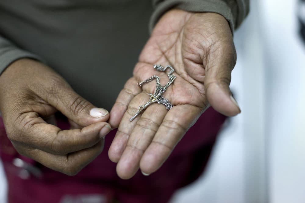 Luci Diaz holds a crucifix her 15-year old grandson gave her before they separated in Tijuana on Nov. 20, 2018. Diaz accompanied her grandson in a migrant caravan so that he can ask U.S. officials for asylum and join his mother in the Bay Area. (David Maung/KQED)