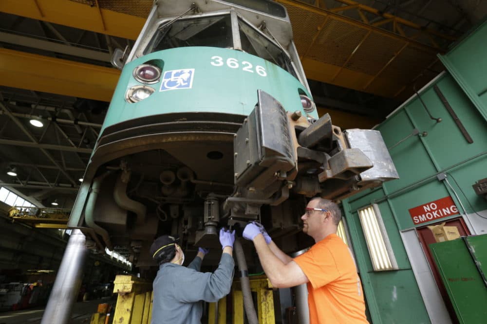 The transportation sector was among those that saw increases in jobs. Here, in this 2015 photo, Rob Cunningham works on a MBTA railcar in Newton, Mass. (Steven Senne/AP)