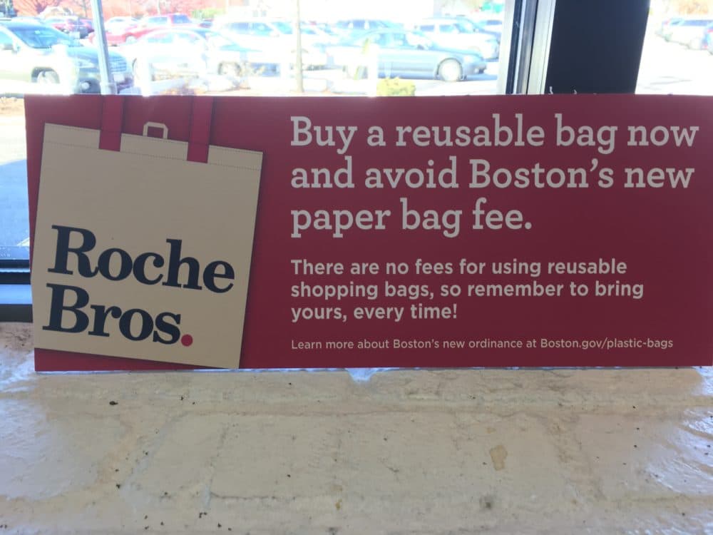 A sign at Roche Bros. warning of the plastic bag ban. (Dan Guzman/WBUR)