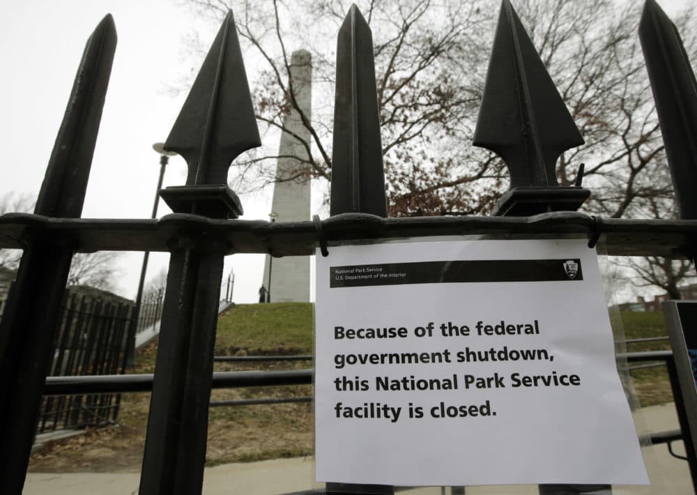A sign is posted on a fence near an entrance to the Bunker Hill Monument Dec. 24 in Boston. The historic site, erected to commemorate the Revolutionary War Battle of Bunker Hill, and run by the National Park Service, was closed due to a partial federal government shutdown. (Steven Senne/AP)