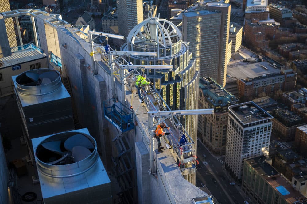 Contractors work on the top of One Dalton Street, 742 feet above Huntington Ave. (Jesse Costa/WBUR)